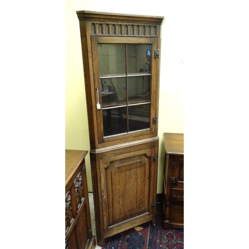 214 - An oak sideboard with carved and linen fold decoration together with a matching corner cupboard and ... 