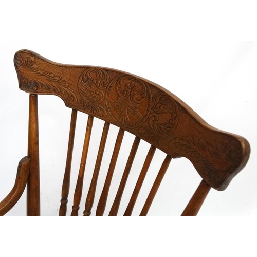 217 - An American oak and bentwood circular seated rocking chair with open arms. 34 1/2'' high