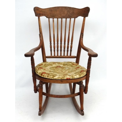 217 - An American oak and bentwood circular seated rocking chair with open arms. 34 1/2'' high