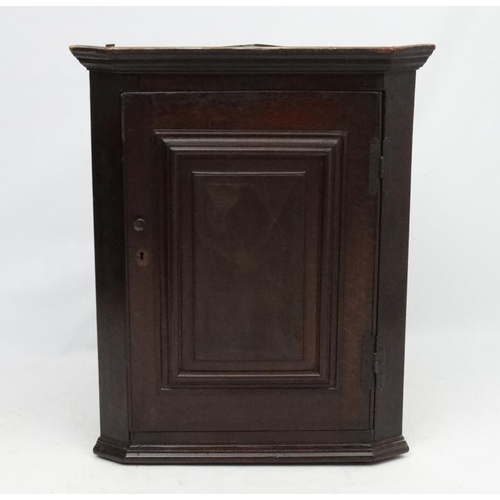 220 - A 19thC oak hanging corner cupboard with parquetry inlay to door. 40 3/4'' high