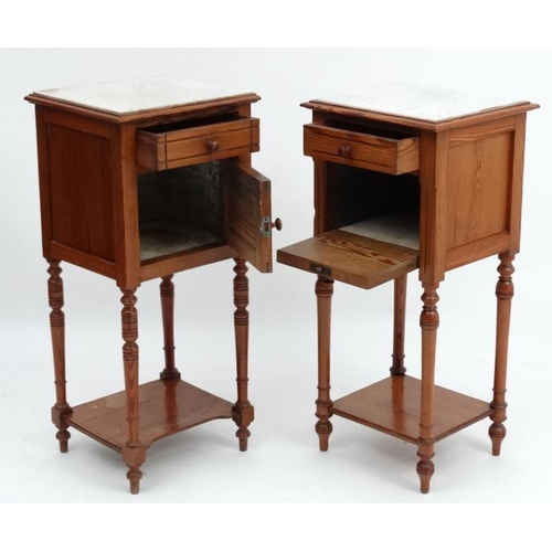 224 - A pair of early 20thC matched Continental marble topped pine bedside tables approx 34'' high x 15 3/... 