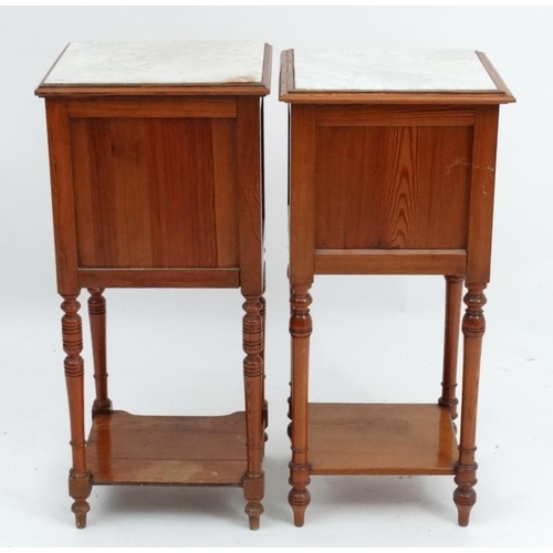 224 - A pair of early 20thC matched Continental marble topped pine bedside tables approx 34'' high x 15 3/... 