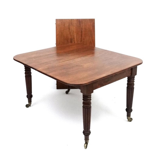 229 - An early 19thC mahogany pull out / drawer out extending dining table by J Cranston in the manner of ... 