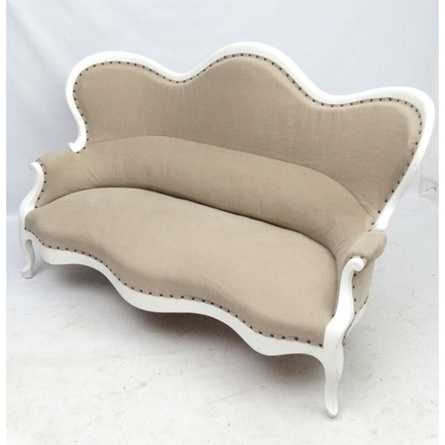 245 - A 19thC Continental shaped settee with white painted wooden frame and calico like upholstery. 68'' w... 