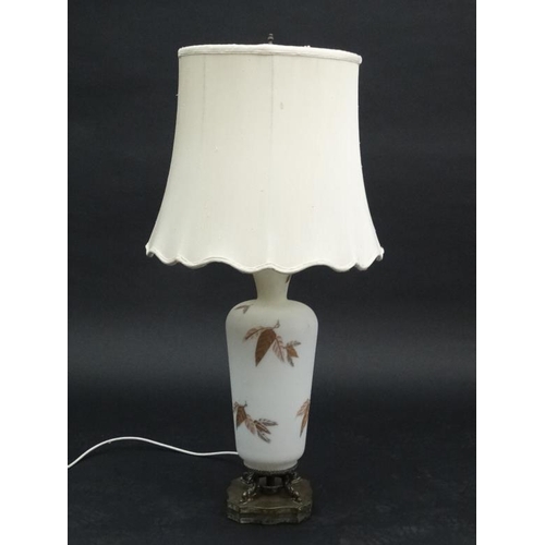 250 - A handed painted white satin glass table lamp with a bronze squared serpentine shaped base and raw s... 