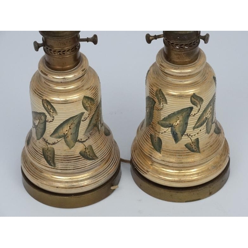 251 - A pair of early 20thC oil lamp conversions now formed as electric table lamps with gilded brass and ... 