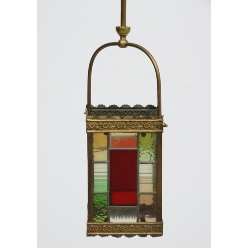 253 - An Edwardian brass and leaded stained glass multicoloured pendant wall lantern / light shade. The wh... 