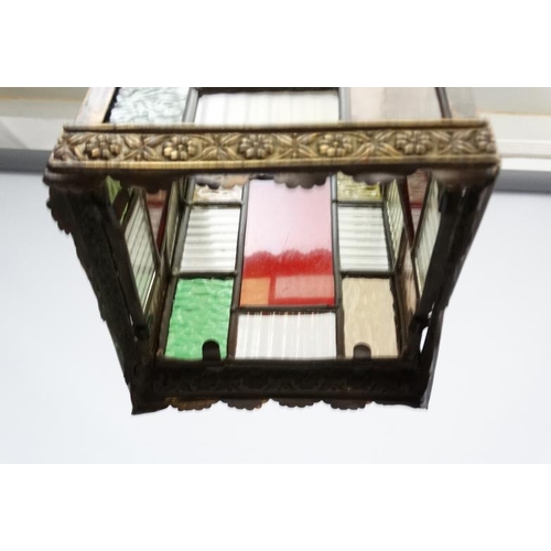 253 - An Edwardian brass and leaded stained glass multicoloured pendant wall lantern / light shade. The wh... 