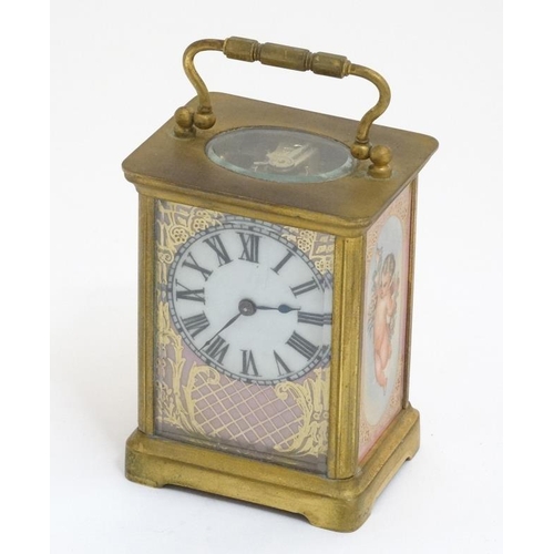 261 - Carriage Clock : a porcelain panelled 5 1/4'' high ( handle up) carriage clock ( timepiece ) with ov... 