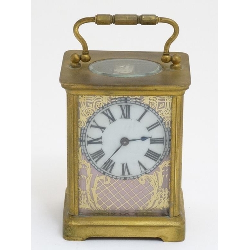 261 - Carriage Clock : a porcelain panelled 5 1/4'' high ( handle up) carriage clock ( timepiece ) with ov... 