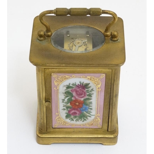 261 - Carriage Clock : a porcelain panelled 5 1/4'' high ( handle up) carriage clock ( timepiece ) with ov... 