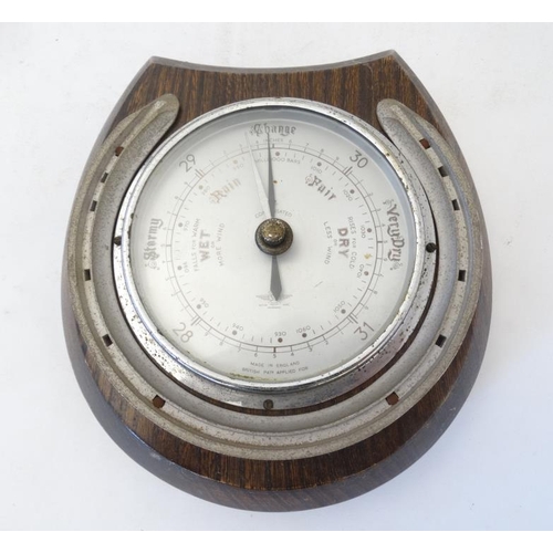 262 - Shortland Smith : a wall mounting   20 thC oak cased aneroid barometer with applied horseshoe decora... 