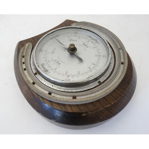 262 - Shortland Smith : a wall mounting   20 thC oak cased aneroid barometer with applied horseshoe decora... 