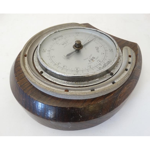 262 - Shortland Smith : a wall mounting   20 thC oak cased aneroid barometer with applied horseshoe decora... 