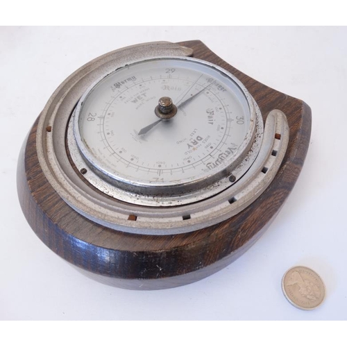 262 - Shortland Smith : a wall mounting   20 thC oak cased aneroid barometer with applied horseshoe decora... 