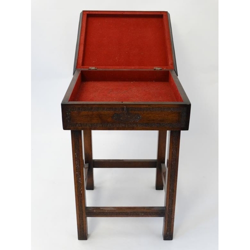 325 - Militaria : An unusual small work table , the hinged lidded top carved with the insignia of the Ross... 