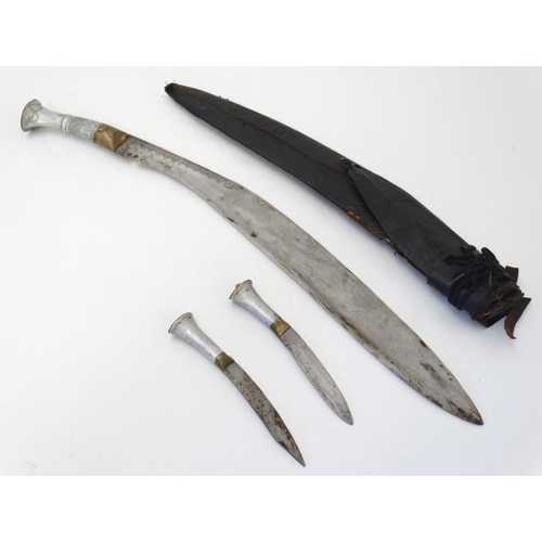 327 - Militaria : An early 20thC unusually large Nepalese Kukri knife , 22'' blade with a 5'' brass and wh... 