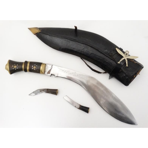 328 - Militaria : An mid 20thC Nepalese / Indian Kukri knife , 11 1/2'' blade with a 4'' brass and hardwoo... 