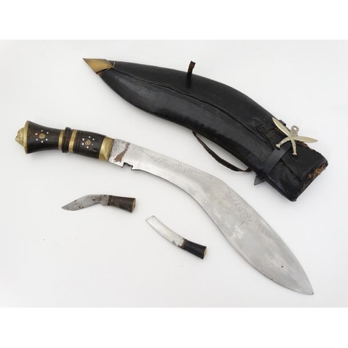 328 - Militaria : An mid 20thC Nepalese / Indian Kukri knife , 11 1/2'' blade with a 4'' brass and hardwoo... 