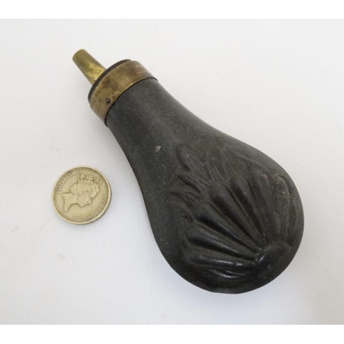 336 - Shooting : A 19thC pewter Pistol Powder Flask , having sunburst decoration and brass cap . 4 1/4'' l... 