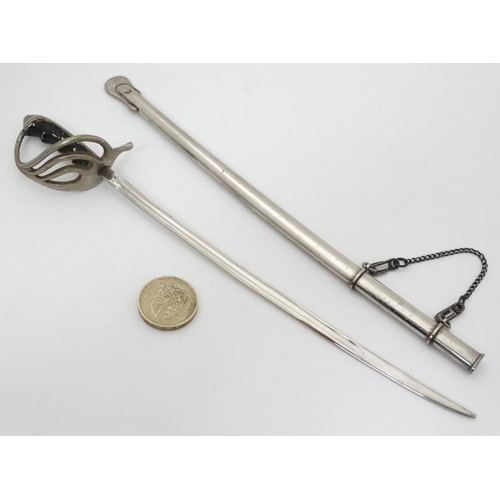 340 - Militaria : A novelty Letter Opener formed as an British Army Officer's sword , together with scabba... 