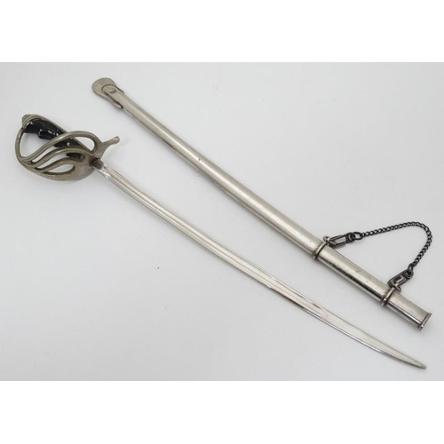 340 - Militaria : A novelty Letter Opener formed as an British Army Officer's sword , together with scabba... 