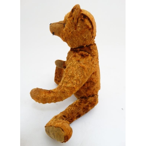 386 - Toy: A late 20thC cinnamon coloured Teddy bear having black stitched nose , fabric pads, plastic sho... 