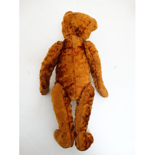 386 - Toy: A late 20thC cinnamon coloured Teddy bear having black stitched nose , fabric pads, plastic sho... 