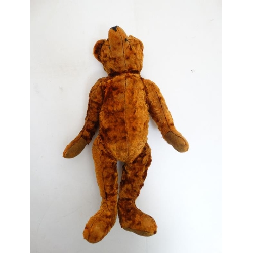 386 - Toy: A late 20thC cinnamon coloured Teddy bear having black stitched nose , fabric pads, plastic sho... 