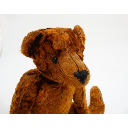 386 - Toy: A late 20thC cinnamon coloured Teddy bear having black stitched nose , fabric pads, plastic sho... 