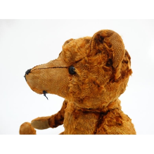 386 - Toy: A late 20thC cinnamon coloured Teddy bear having black stitched nose , fabric pads, plastic sho... 