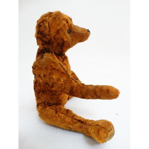 386 - Toy: A late 20thC cinnamon coloured Teddy bear having black stitched nose , fabric pads, plastic sho... 