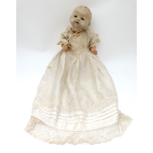 387 - Toy: A German Bisque Childs doll, having blue glass painted eyes , painted features and hinged limbs... 