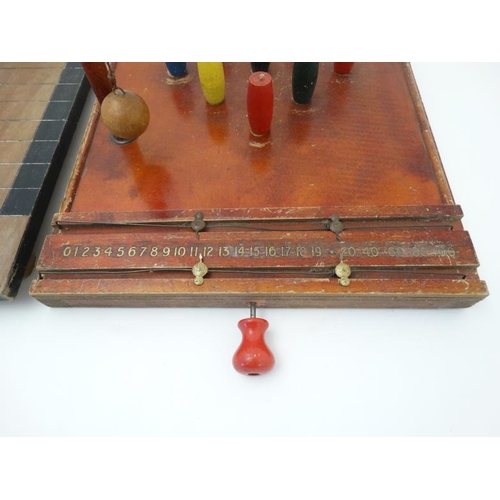 396 - Toys: A mid 20thC wooden table skittles board with integral score board and gilt coloured numbers to... 