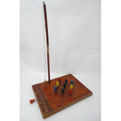 396 - Toys: A mid 20thC wooden table skittles board with integral score board and gilt coloured numbers to... 