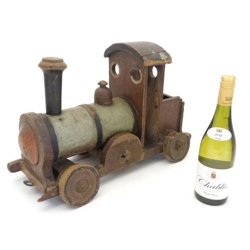 397 - Toy: An early 20thC large wooden hand made toy steam train , having green painted boiler and black c... 