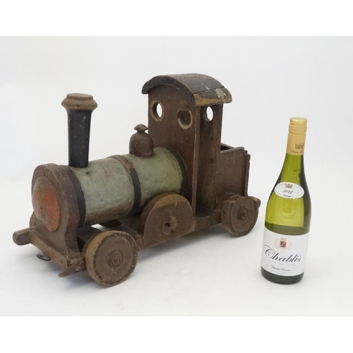 397 - Toy: An early 20thC large wooden hand made toy steam train , having green painted boiler and black c... 