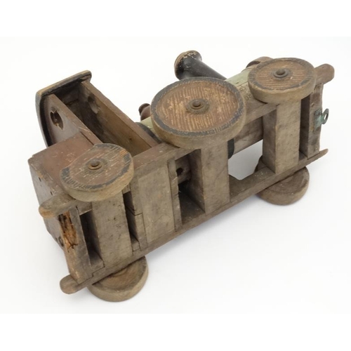 397 - Toy: An early 20thC large wooden hand made toy steam train , having green painted boiler and black c... 