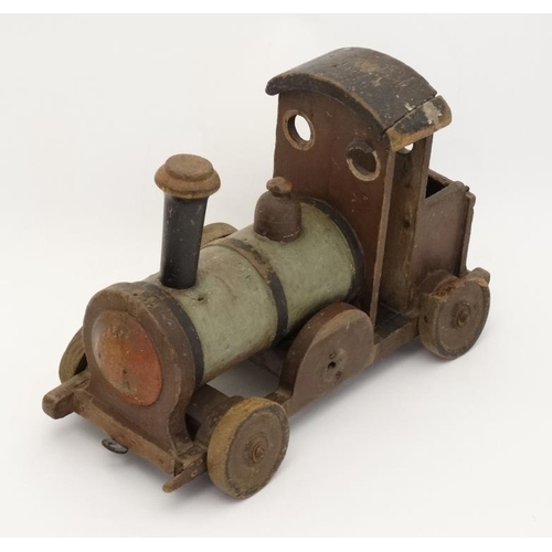 397 - Toy: An early 20thC large wooden hand made toy steam train , having green painted boiler and black c... 