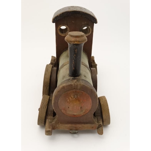 397 - Toy: An early 20thC large wooden hand made toy steam train , having green painted boiler and black c... 