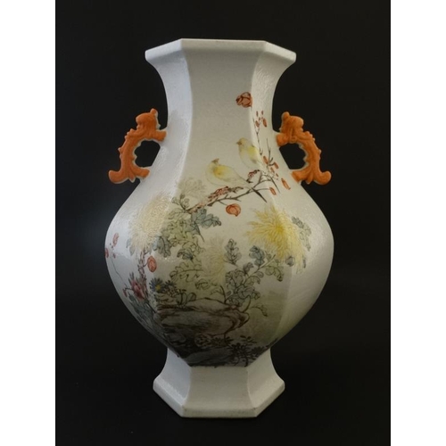 401 - An early 20thC Chinese famille rose twin handled hexagonal formed  vase , decorated with birds among... 