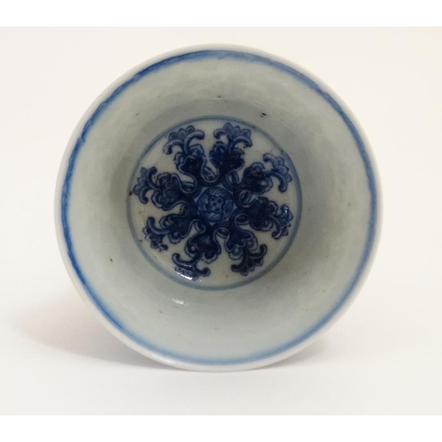 404 - A Chinese blue and white stem cup , the outside decorated with stylised chrysanthemums and symbols ,... 