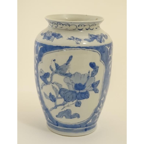 406 - An Oriental blue and white vase decorated with exotic birds and flowers. 8'' high.