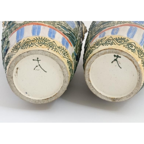 408 - A pair of Japanese Satsuma Moriage twin handled vases, each decorated in polychrome with figures , t... 