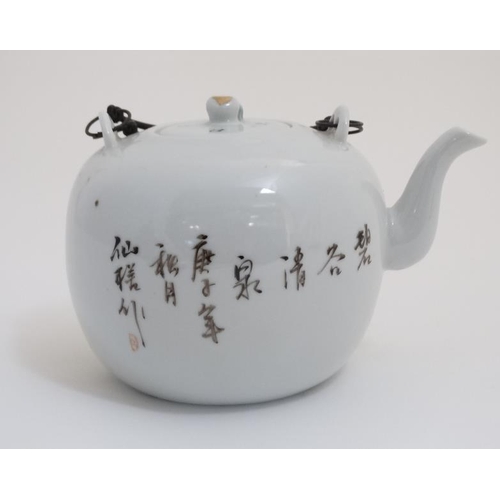 410 - A Chinese famille rose teapot decorated with figures seated under a tree, script to reverse and the ... 