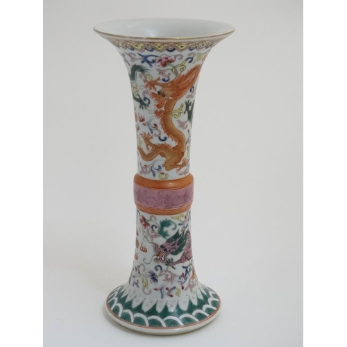 414 - A Chinese famille rose Gu vase , decorated with 4 clawed dragons and pearls of wisdom amongst scroll... 