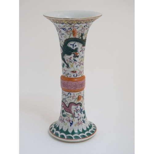 414 - A Chinese famille rose Gu vase , decorated with 4 clawed dragons and pearls of wisdom amongst scroll... 