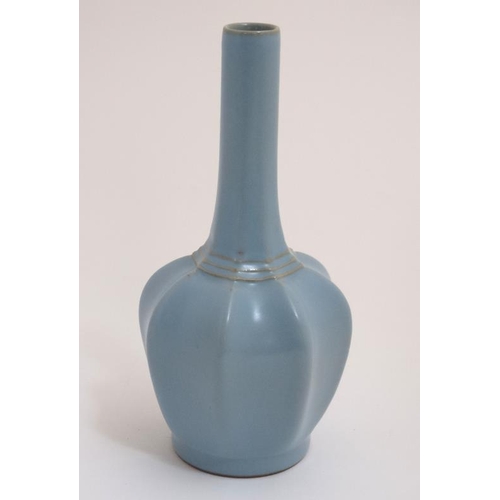 415 - A Chinese Ru ware style bottle vase in a duck egg blue glaze having lobed body and brown / gilt colo... 