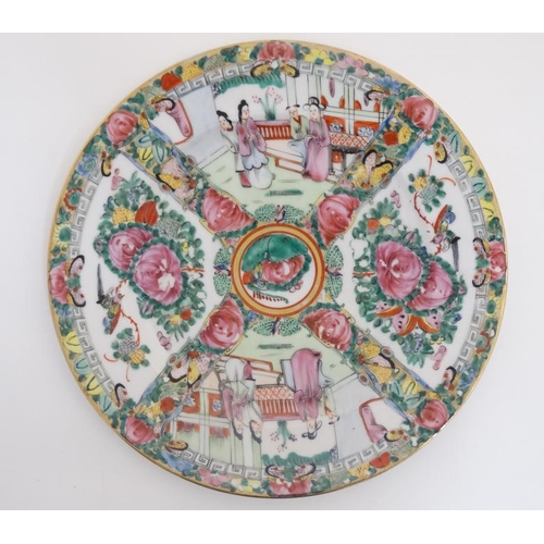 417 - A Chinese Cantonese famille rose plate , having four panels decorated with figures in interior scene... 