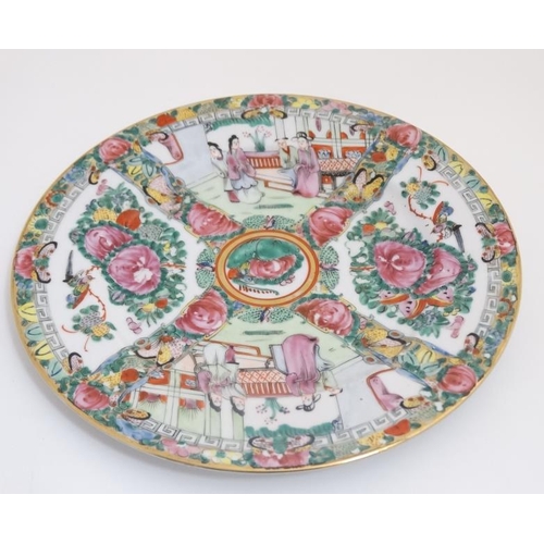 417 - A Chinese Cantonese famille rose plate , having four panels decorated with figures in interior scene... 